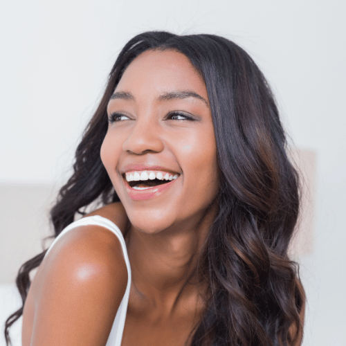 A young woman smiling with bright white, beautiful teeth